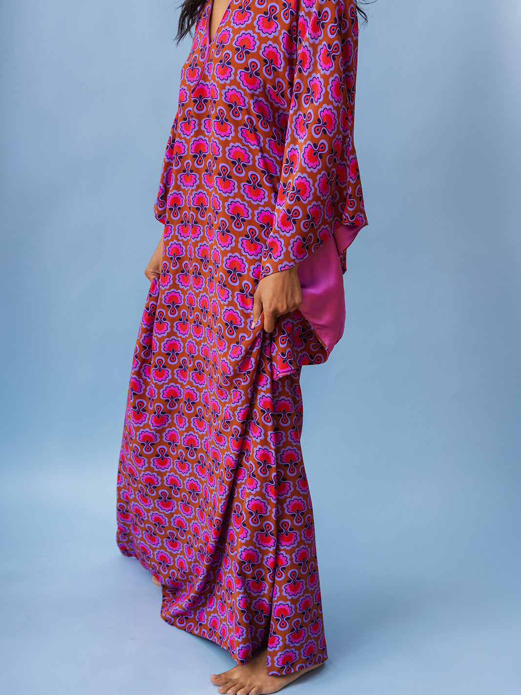 Side view of the floor-length hem, Dahlia Seed matte viscose kaftan