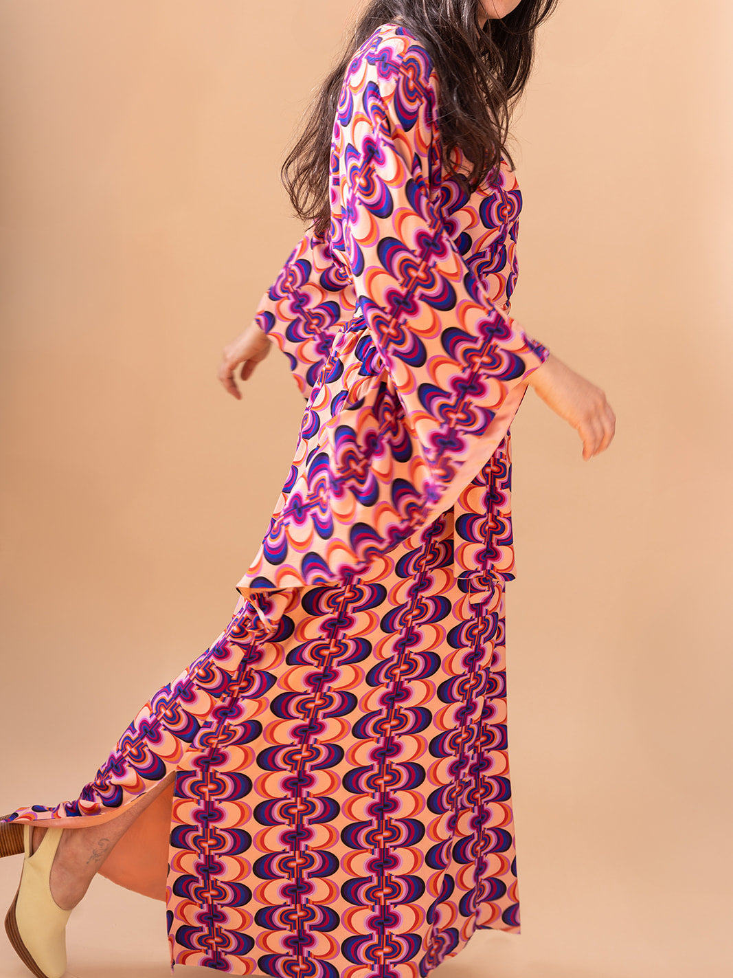 Side view mid-stride showing the side slit, Good Vibrations matte viscose kaftan
