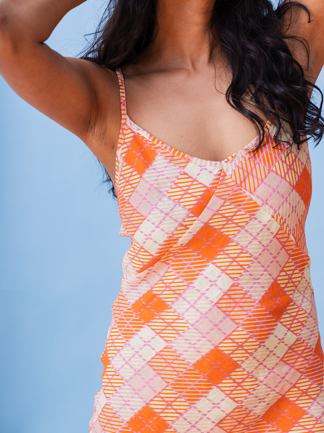 Close-up of the V-neckline and bias-cut plaid, Candied Plaid organic linen sundress
