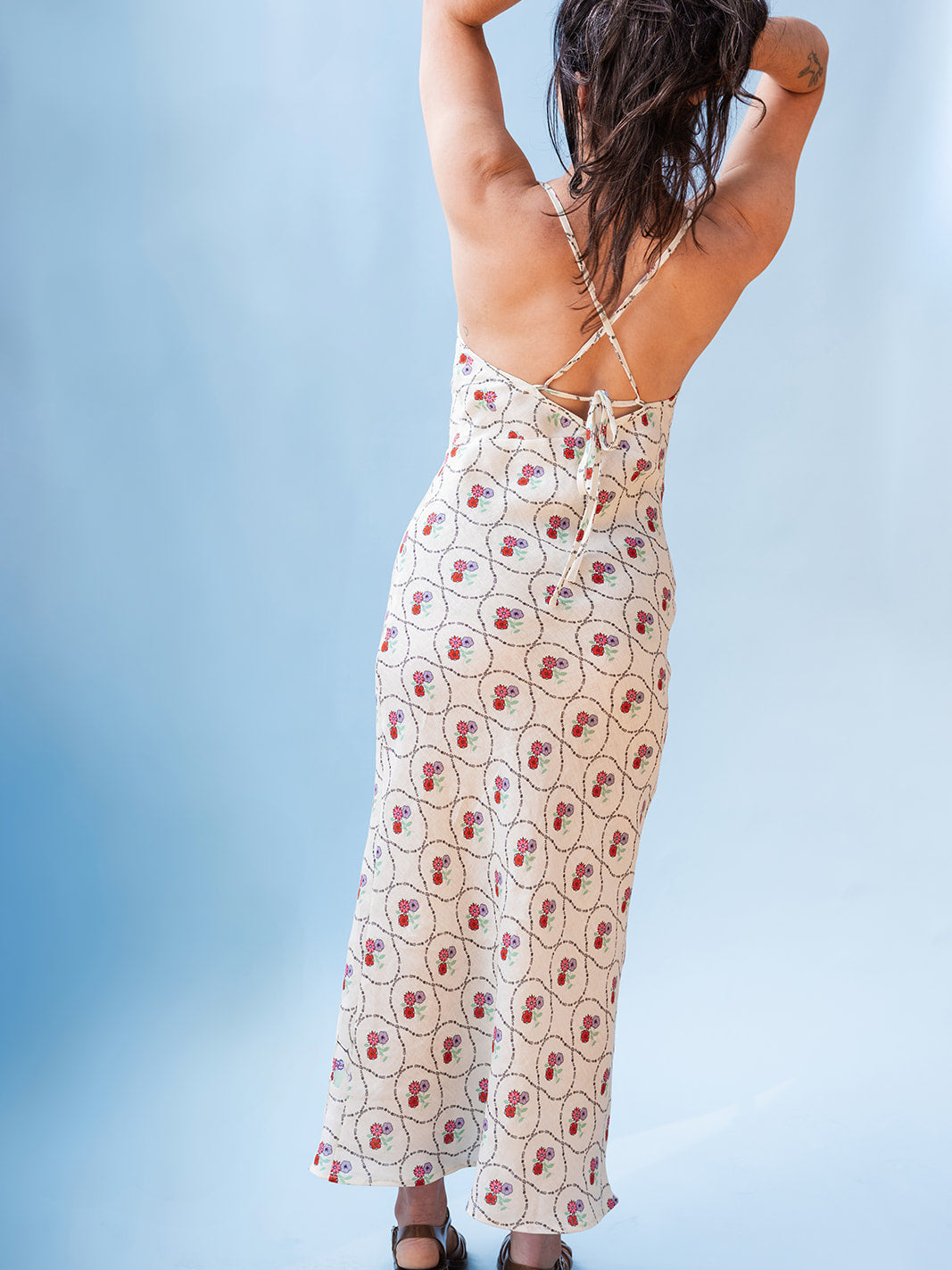 Back view showing the crossed tie-back straps, Wildflowers organic linen sundress